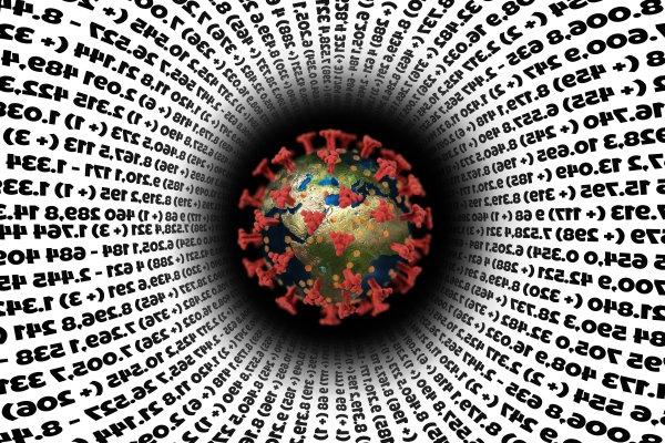 COVID spike protein surrounded by data and numbers.